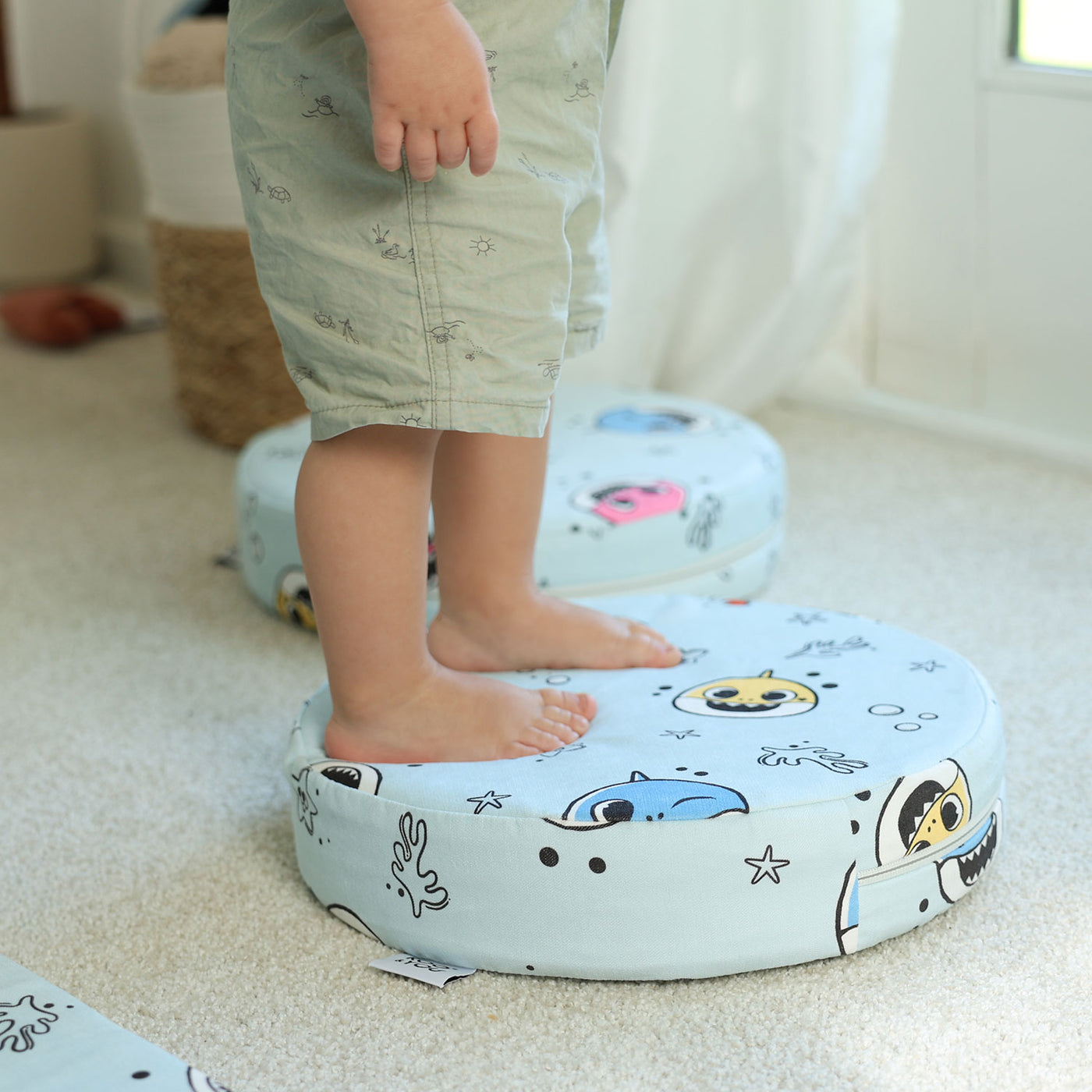 Kid balancing on Baby Shark™ x Roo & You™ Stepping Stones during playtime.
