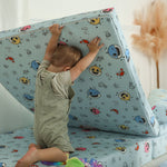 Kid lifting the Baby Shark™ x Roo & You™ Joey Play Couch base to build.