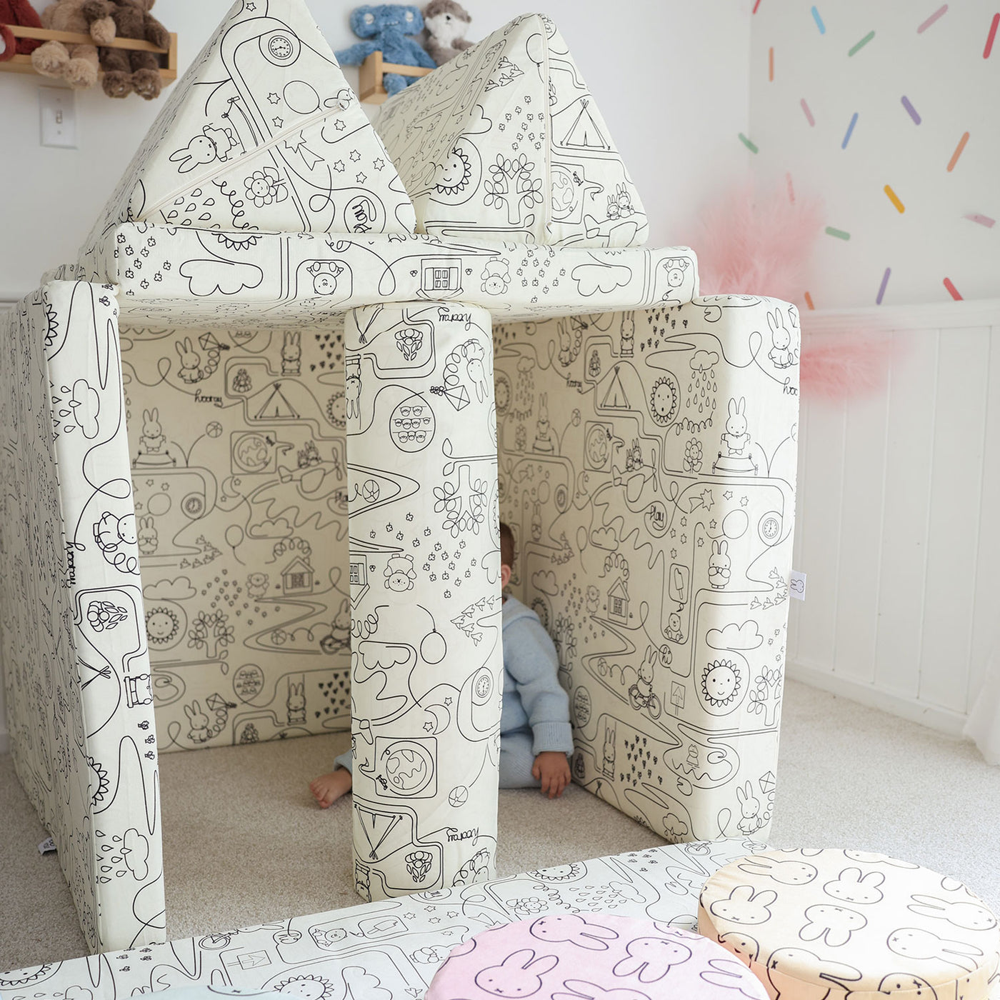 Toddler playing with Miffy™ x Roo & You™ Joey Play Couch covered in bunny print.