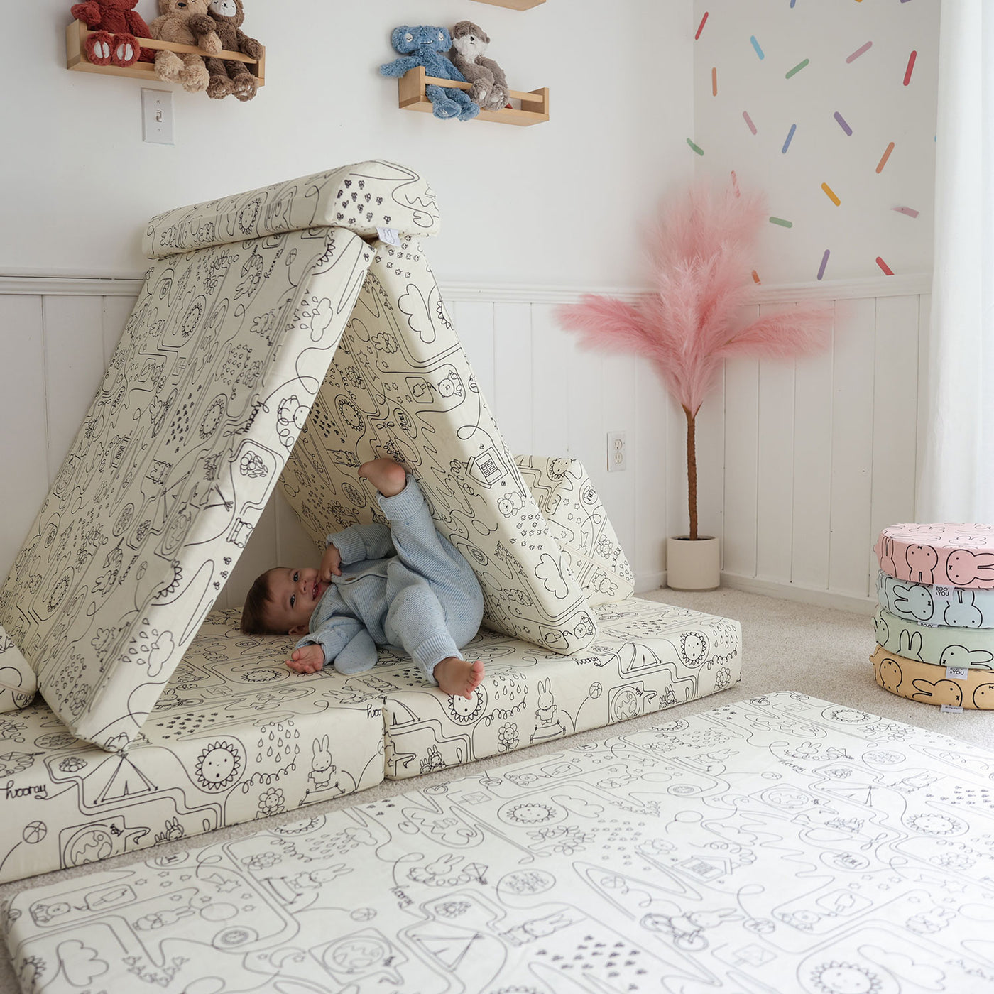 Toddler playing with Miffy™ x Roo & You™ Joey Play Couch covered in bunny print.