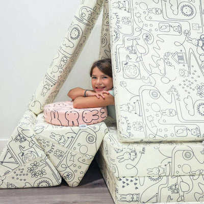 Little girl playing with Miffy™ x Roo & You™ Joey Play Couch covered in bunny print.