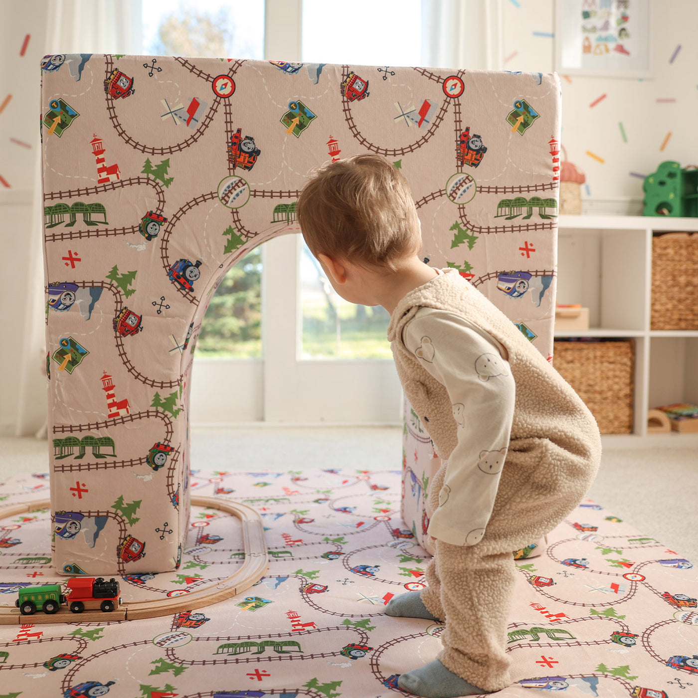 Child playing with Thomas Arch + Armor with train track
