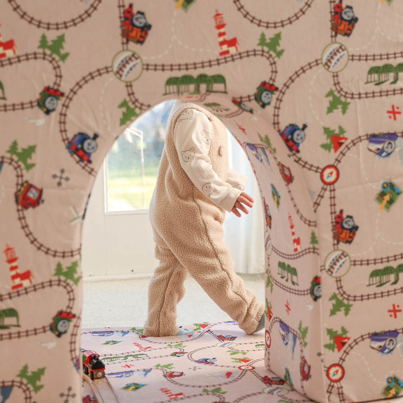 Child playing with Thomas Arch + Armor with train track
