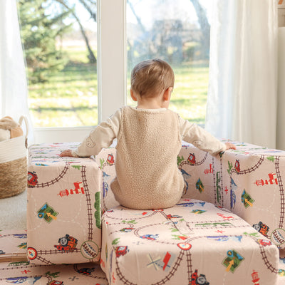 Child playing with Thomas Arch + Armor with train track