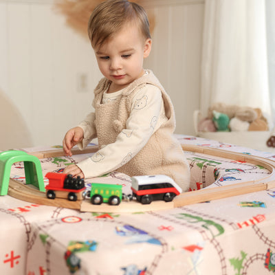 Child playing with Thomas Arch + Armor with train track