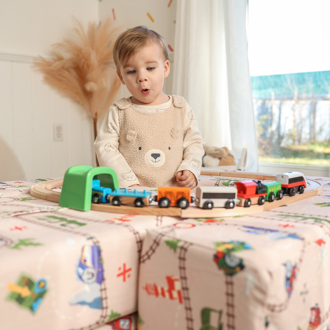 Child playing with Thomas Arch + Armor with train track