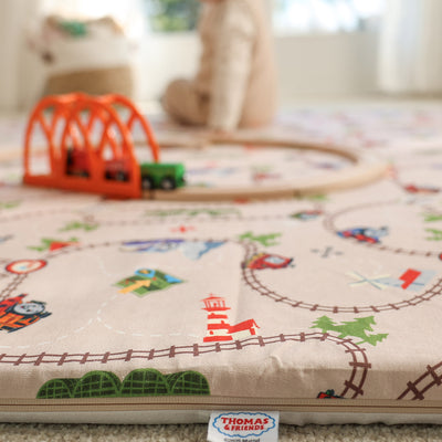 Child playing on Thomas & Friends play mat in playroom