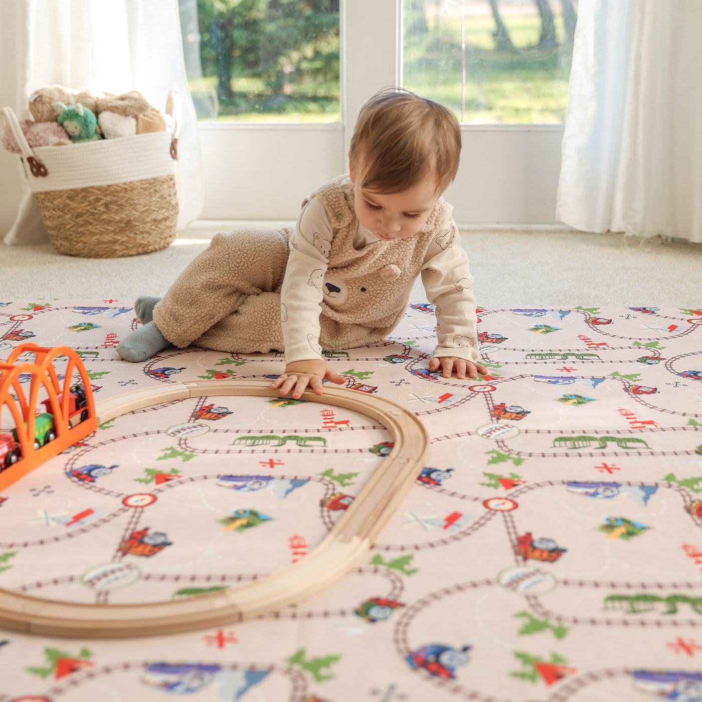 Child playing on Thomas & Friends play mat in playroom