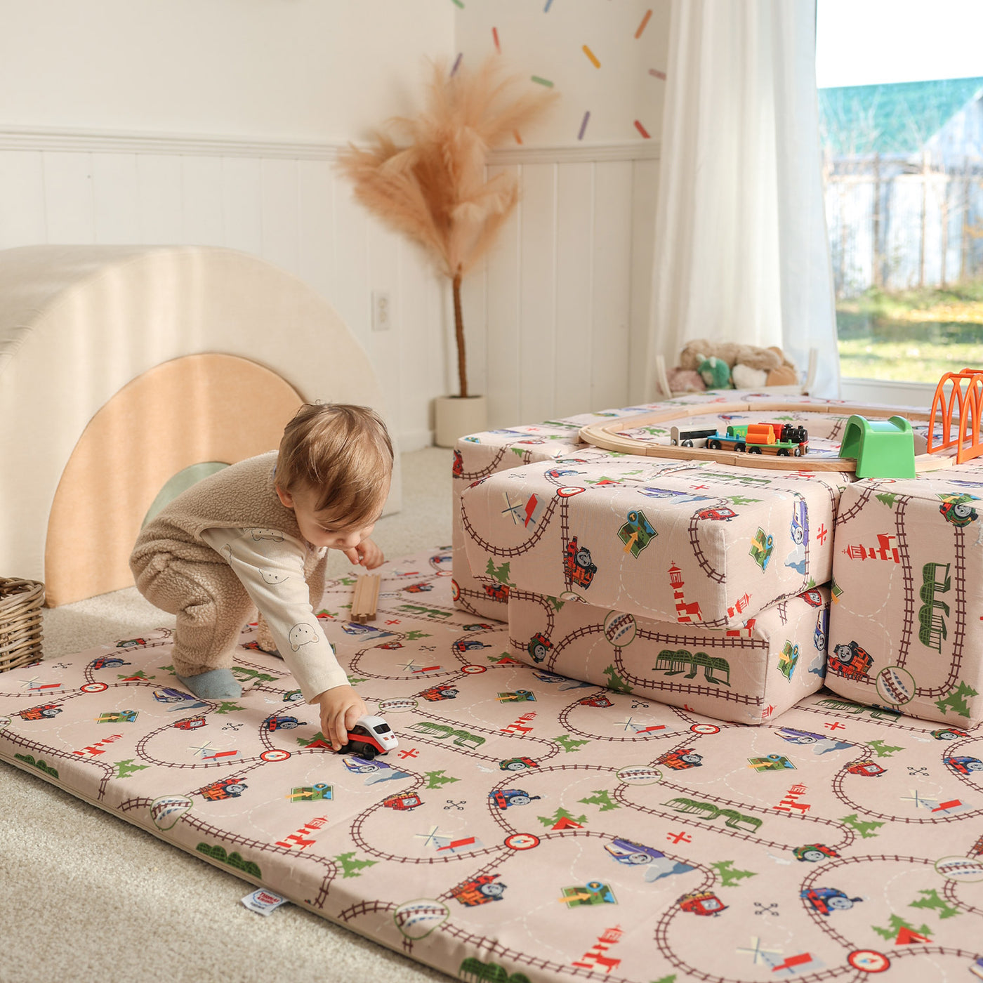 Child playing on Thomas & Friends play mat in playroom