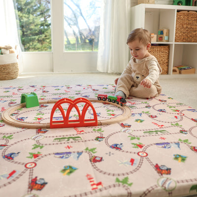 Child playing on Thomas & Friends play mat in playroom